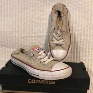 Converse Sz 8 tan eyelet sneakers with red trim.
